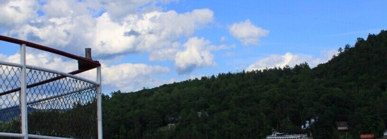 Tourists watching tourists do touristy things. Onboard the Mohican, watching Para-sailors, and the paddleboat Minnie-Ha Ha steam past.