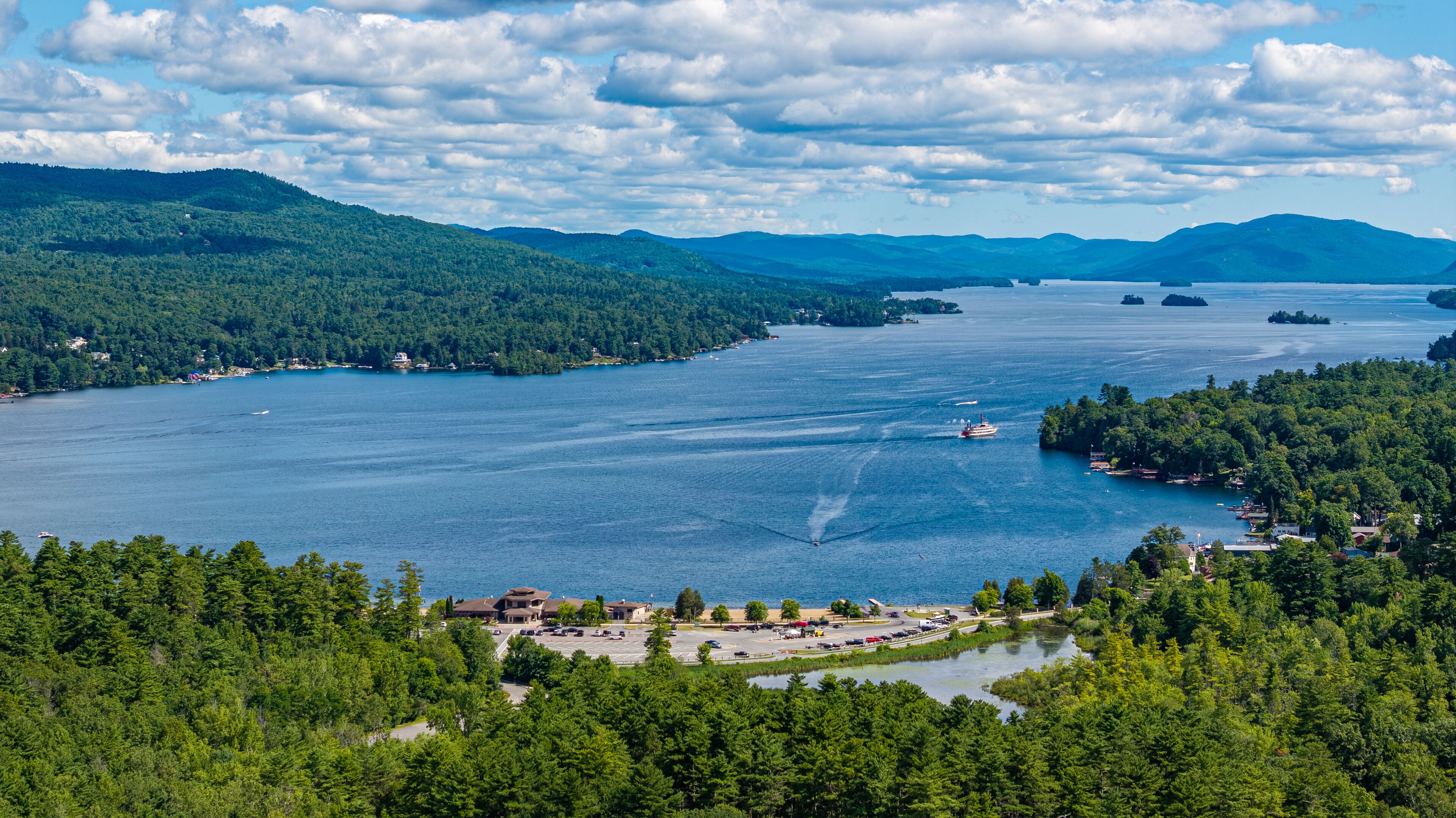 A lake surrounded by dense forests and mountains.