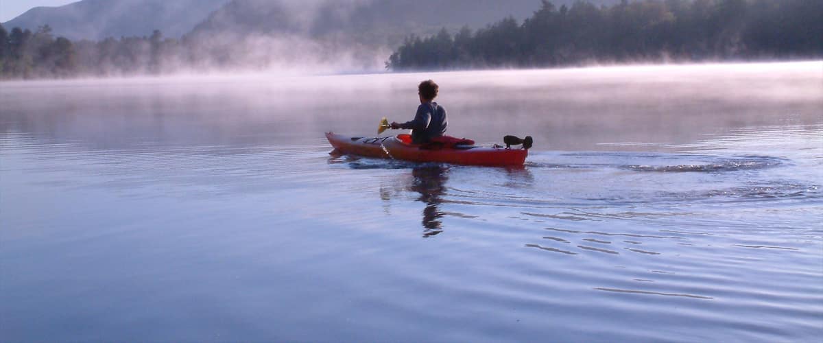 Lake Placid featuring kayaking or canoeing, a lake or waterhole and mist or fog