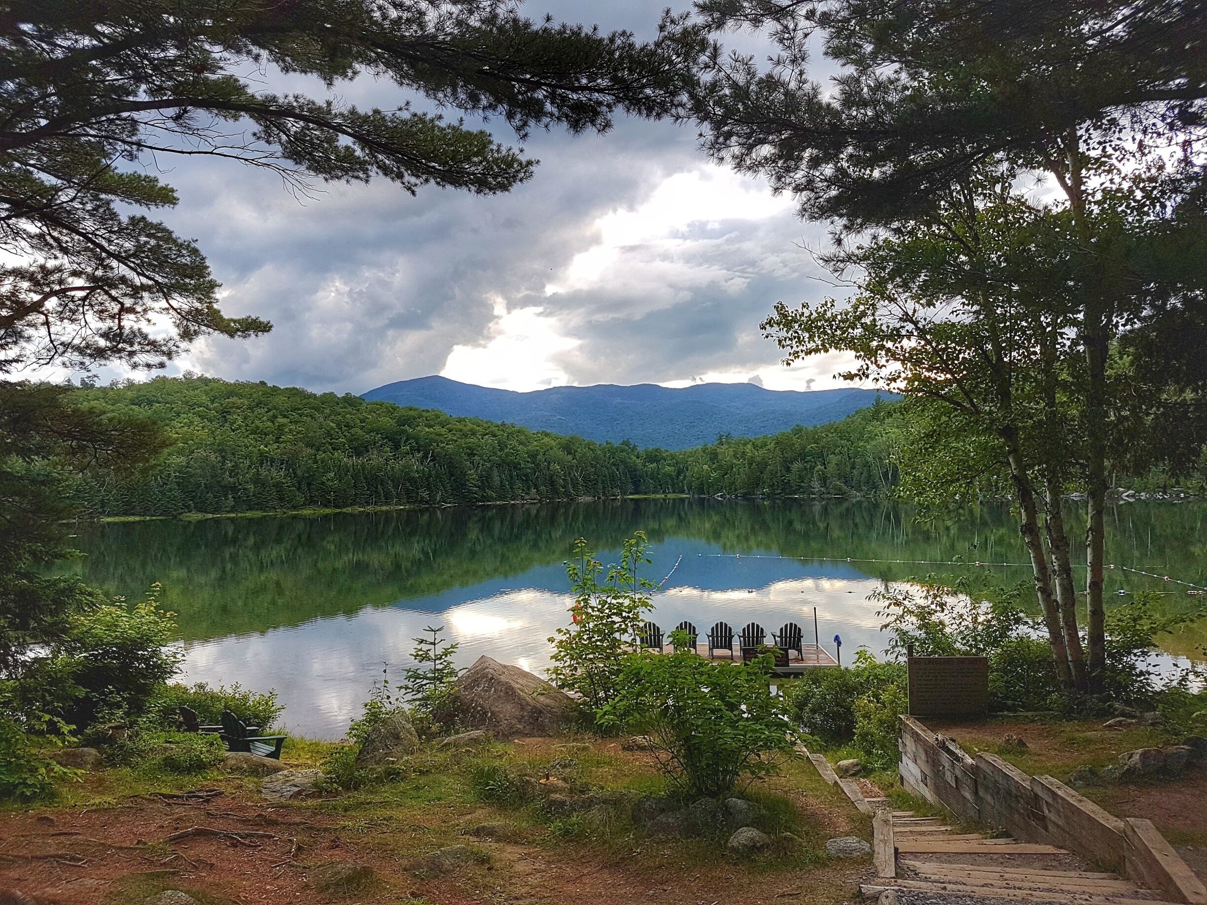 Adirondack Loj is a gorgeous place to stay while hiking in the Adirondacks. This lake is perfect to jump in for a swim after a long day of hiking! #Takeahike 