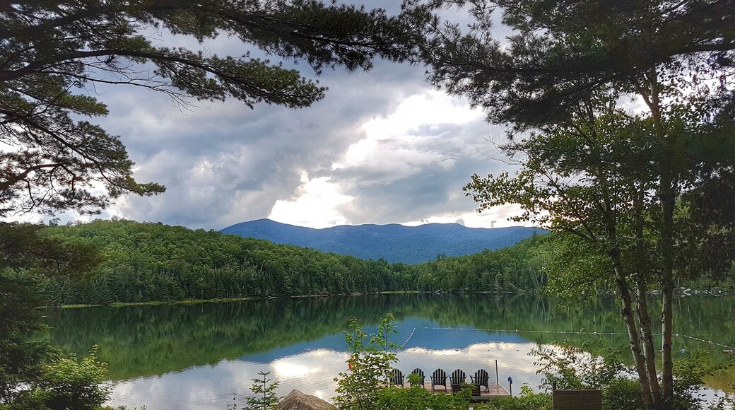 Adirondack Loj is a gorgeous place to stay while hiking in the Adirondacks. This lake is perfect to jump in for a swim after a long day of hiking! #Takeahike