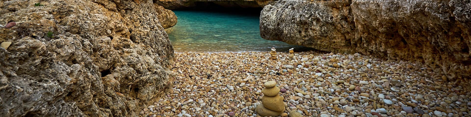 Small rocky beach at Wied il-Ghasri bay at Gozo island, Malta