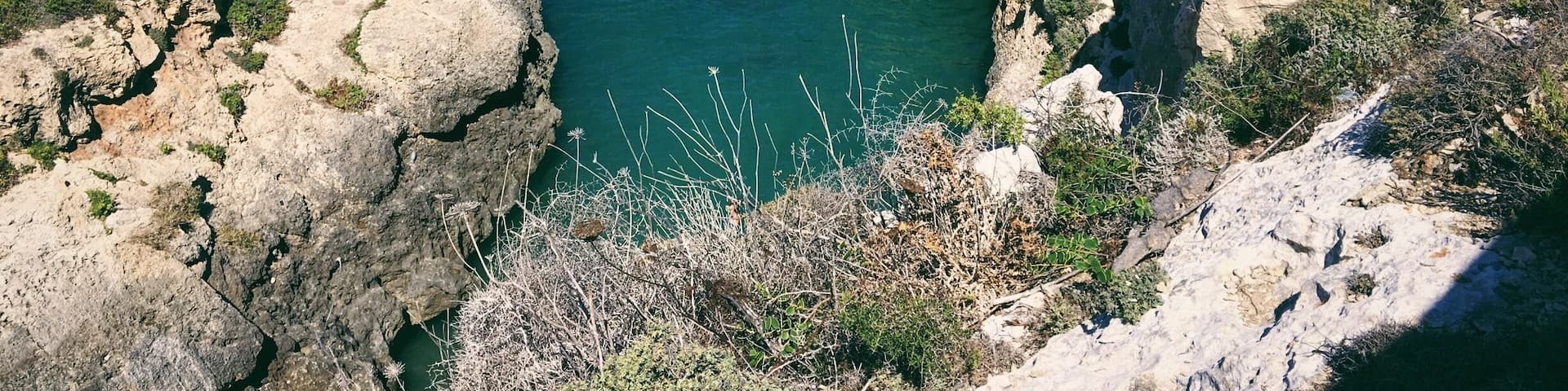 A rocky canyon with a narrow water channel.