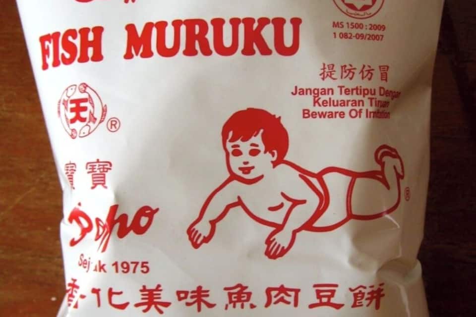 A package of fish muruku with text in multiple languages and a warning label.