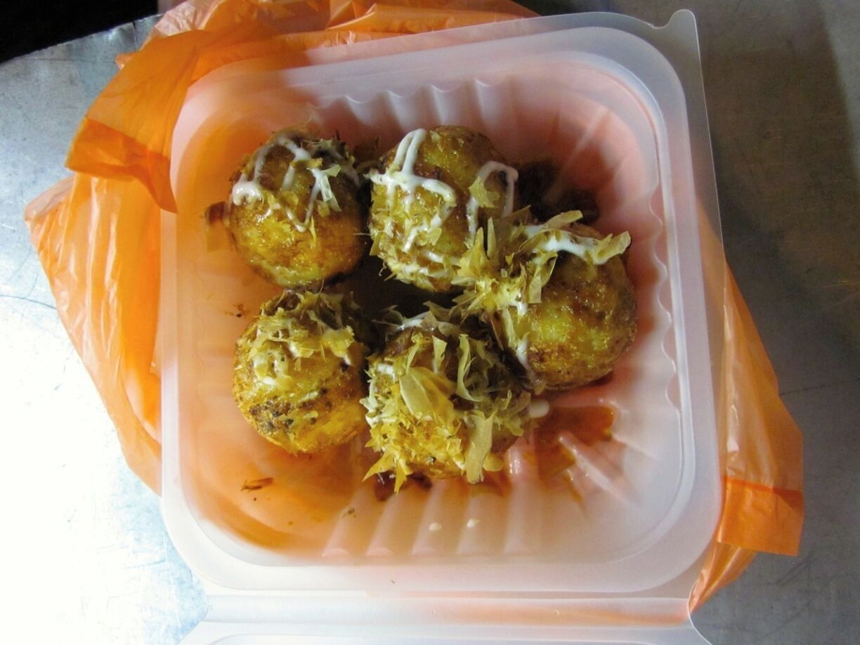 "Takoyaki"

These little round balls of yumminess are light and squishy and filled with different ingredients like cheese, pork, or octopus.  Then covered with a sweet soy sauce and mayonnaise and fishy flakes.  We ate them with small skewers.  These were the appetizers to more delicious delights!!