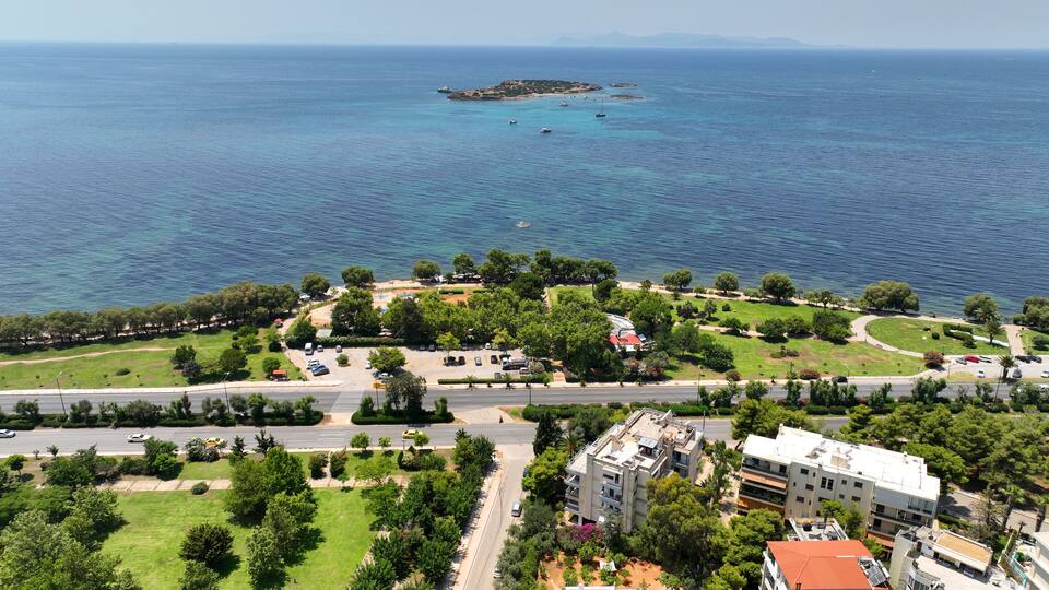 A coastal town with a marina, green parks, and residential buildings.