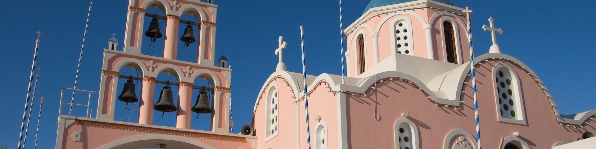 Cycladic orthodox church painted pink in Karterados, Santorini island, Greece.; Shutterstock ID 89024779