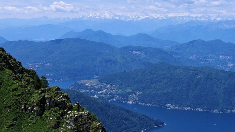 A mountainous landscape with a lake and a town.