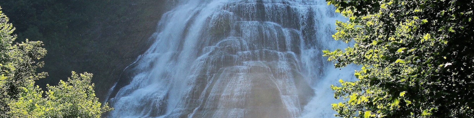 Man fishing at the base of the Ithaca falls.
This is one of over 150 falls in the town of Ithaca, home to Cornell university.
The Ithaca falls has a drop of 150 feet and is175 feet wide, and one of the most powerful waterfalls in the region. It supplied water to the around a 1/2 dozen mills that operated there in the 19th century. The plunge pool is popular among anglers who stop by for lake-run trout and salmon. #waterfalls #fishing