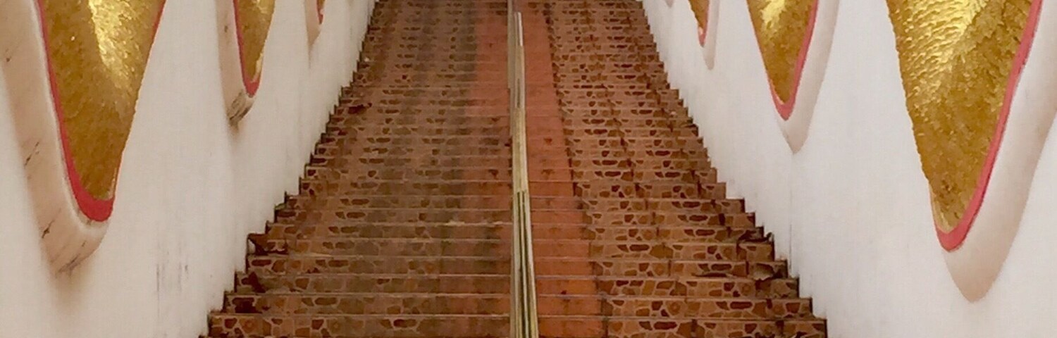 Staircase to the temple entrance of Wat Phrathat Doi Kham. It was a holiday and a Saturday, so there was a steady stream of people flowing up and down. I felt lucky to get this shot of them relatively empty.
At the top, the view of Chiang Mai below is spectacular!