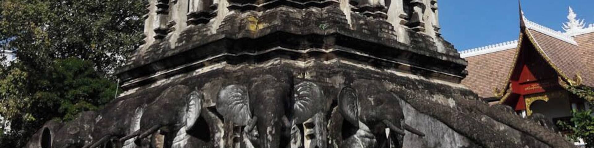 A temple with a golden spire and stone carvings.