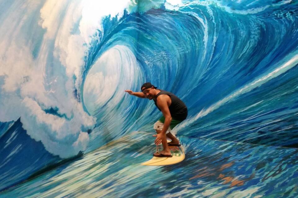 A surfer riding a large wave.