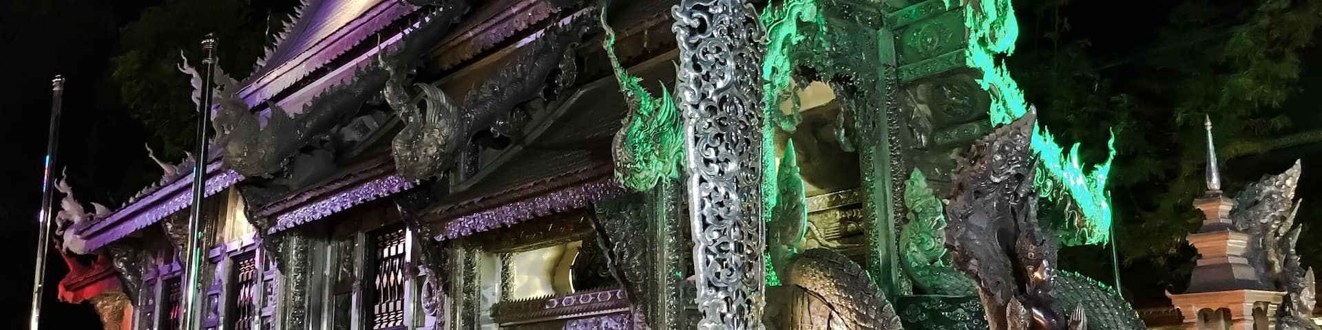 A temple with ornate architecture, including a large dragon statue and intricate carvings.
