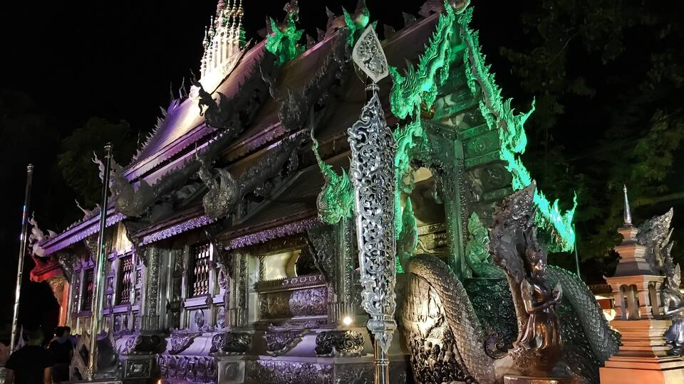 A temple with ornate architecture, including a large dragon statue and intricate carvings.
