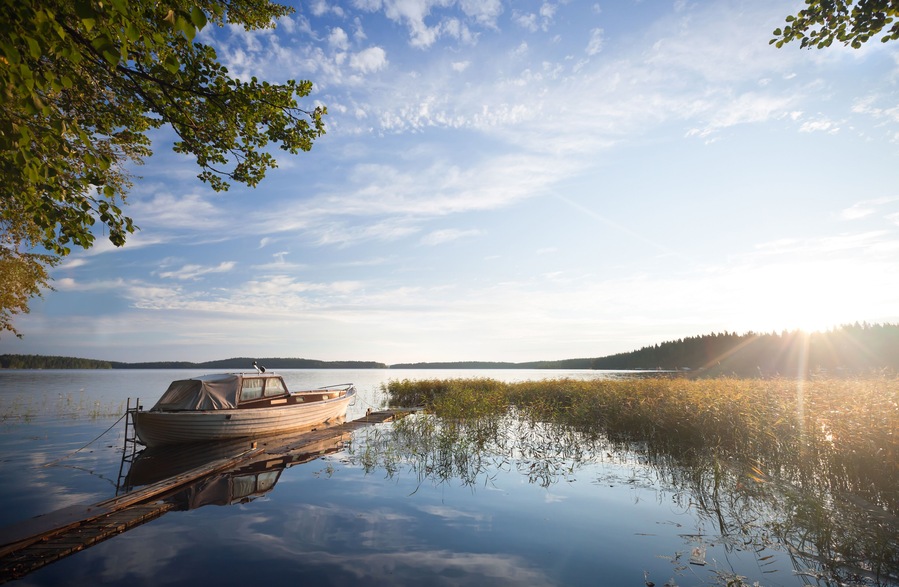 Small fishing boat moored on Saimaa lake in Imatra town, Finland