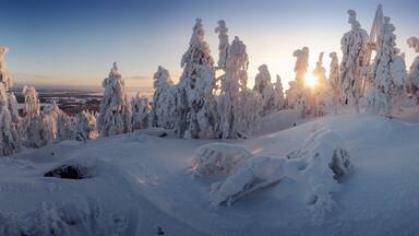 Panorama landscape covered with snow in a ski resort at sunrise. Vuokatti Finland