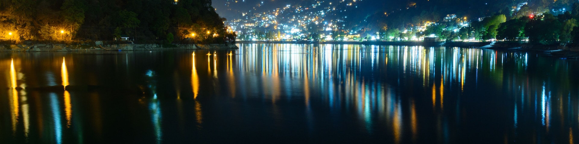 Nightscape of Nainital city with city light reflection on Naini Lake in Uttrakhand, India