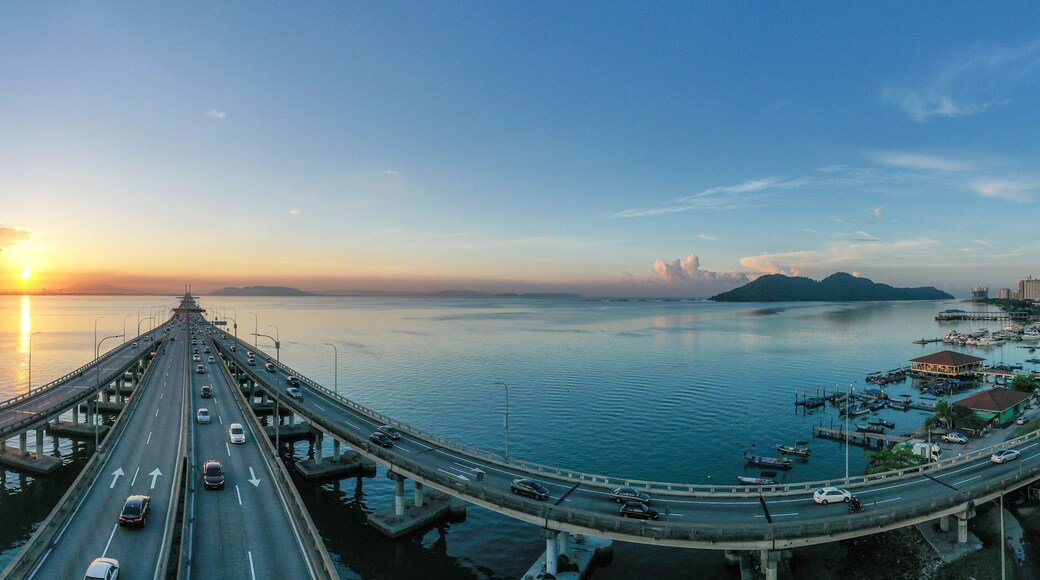 Cars driving across Penang bridge at sunrise, Penang, Malaysia