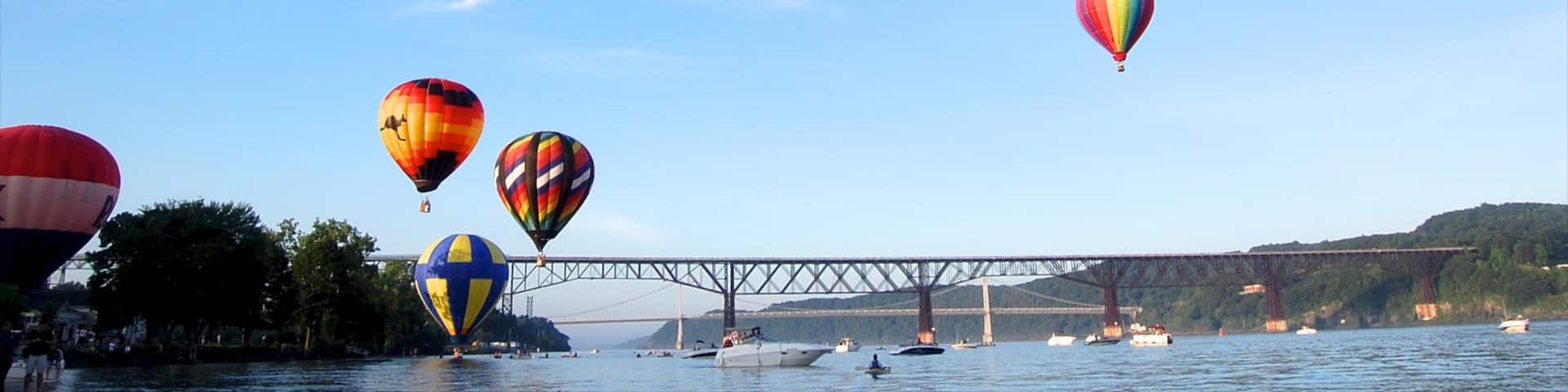 Poughkeepsie which includes ballooning, a bridge and a river or creek