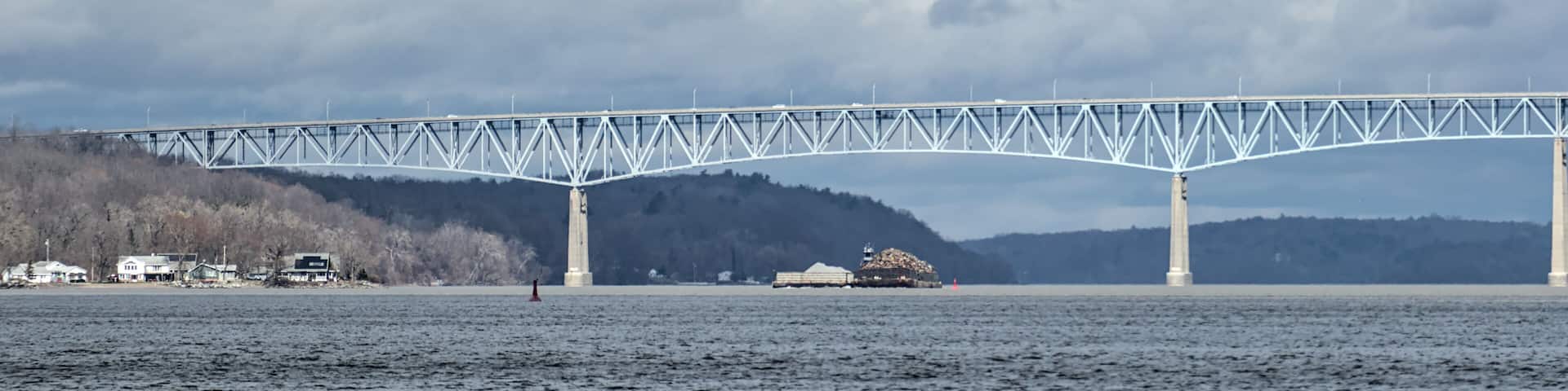 view of the Kingston-Rhinecliff Bridge from Kingston point beach (continuous under deck truss toll bridge across hudson river in new york state)