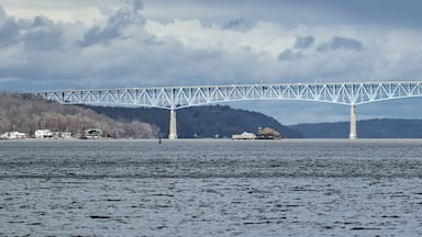 view of the Kingston-Rhinecliff Bridge from Kingston point beach (continuous under deck truss toll bridge across hudson river in new york state)
