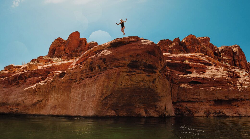 Nothing says adventure like facing your fears head on with an adventure buddy. I had already made the jump, and this is my friend, Brooke, taking the leap while I floated on a kayak below. It takes an adventurous spirit to see the stomach-dropping fear in front of you, and take the leap to overcome it.
Lake Powell is a great spot to find epic rock climbing and cliff jumping. Those who manage to complete the epic climb are rewarded with the thrill of an epic jump! But it is important to always take every precaution, and always check the depth of the water prior to jumping. We found this cliff a swim away from our campsite at Lake Powell. #adventure #cliffjumping