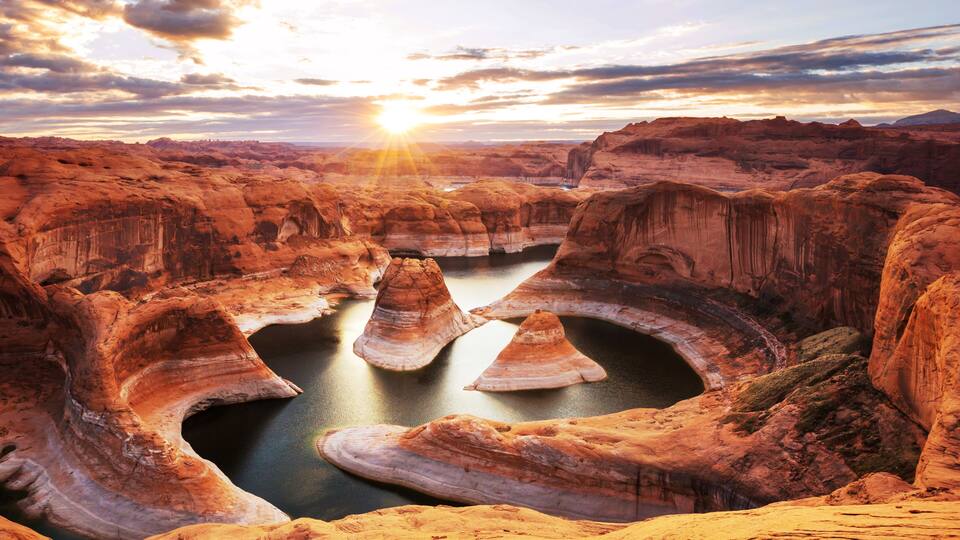 A canyon with layered rock formations and a river.