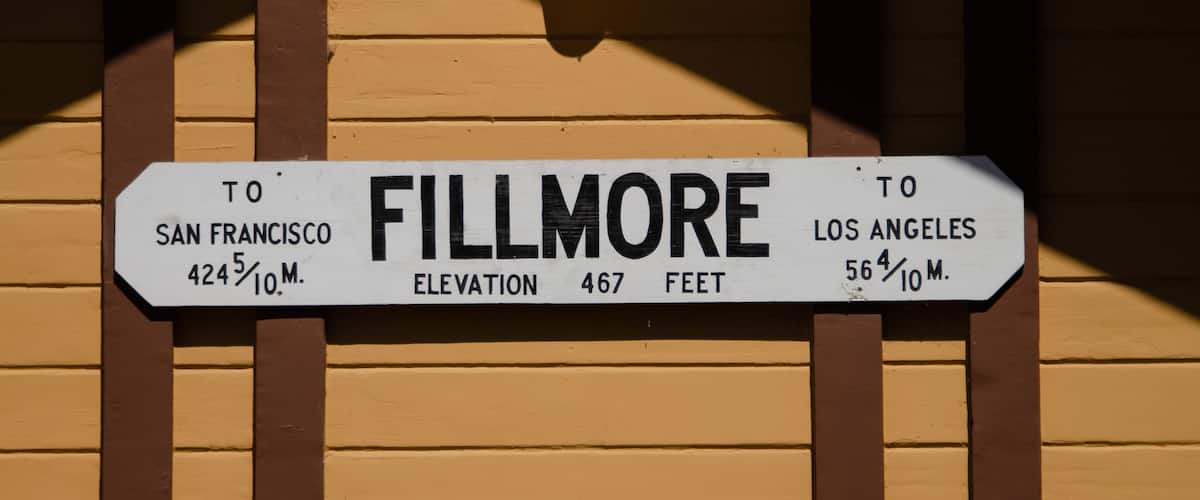 A sign indicating directions to Fillmore, with distances to San Francisco and Los Angeles, and the elevation of Fillmore.