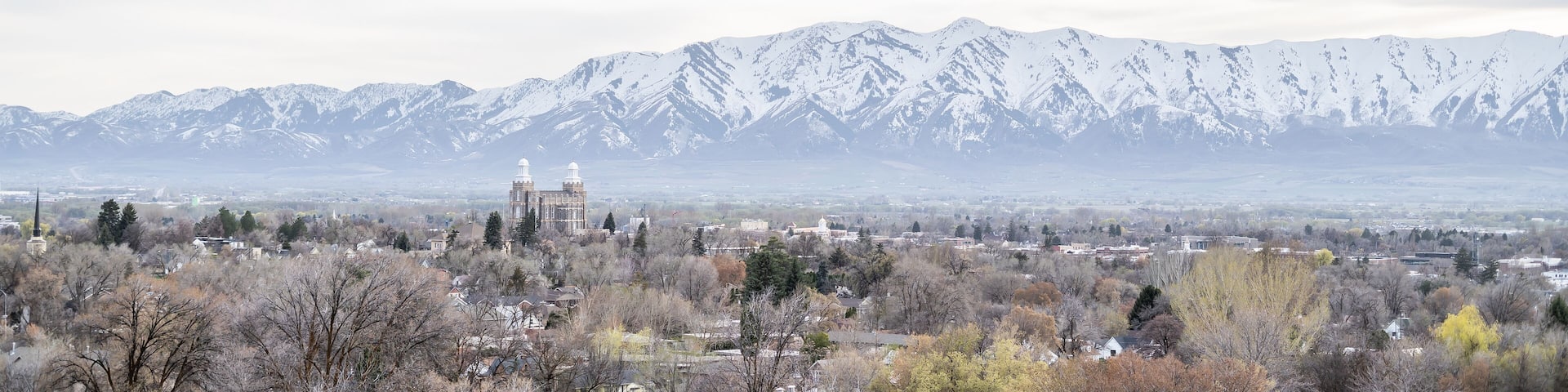 Tops of Logan City Utah White Capped Mountains