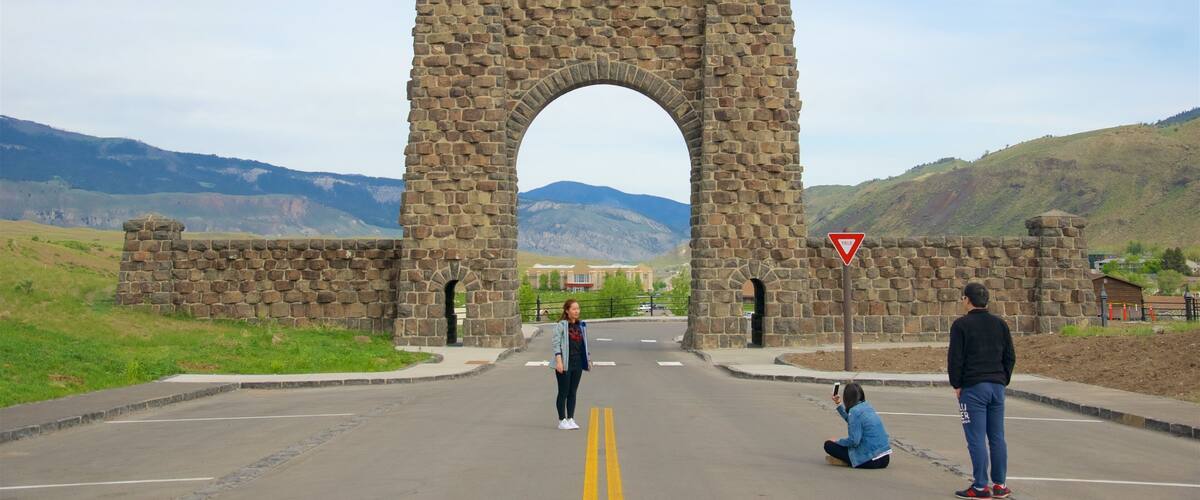 A stone arch bridge with a yield sign on the right.