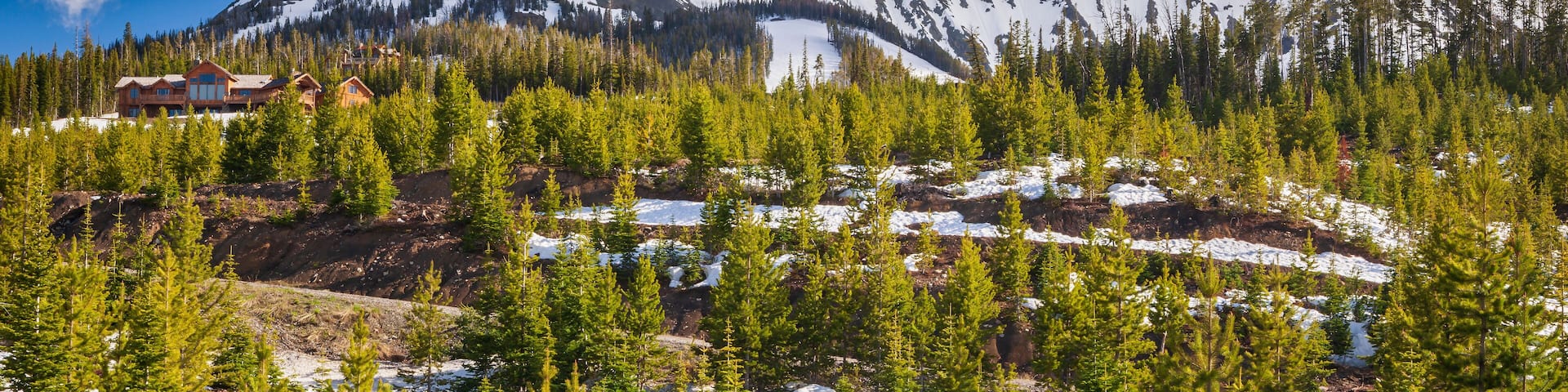 Moonlight Basin ski resort Montana set amongst pine trees and snow capped mountains in the Madison Range of the Rocky Mountains of Big Sky Montana, USA.