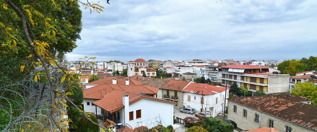 A town with red-tiled roofs, white buildings, and a mix of residential and commercial structures.
