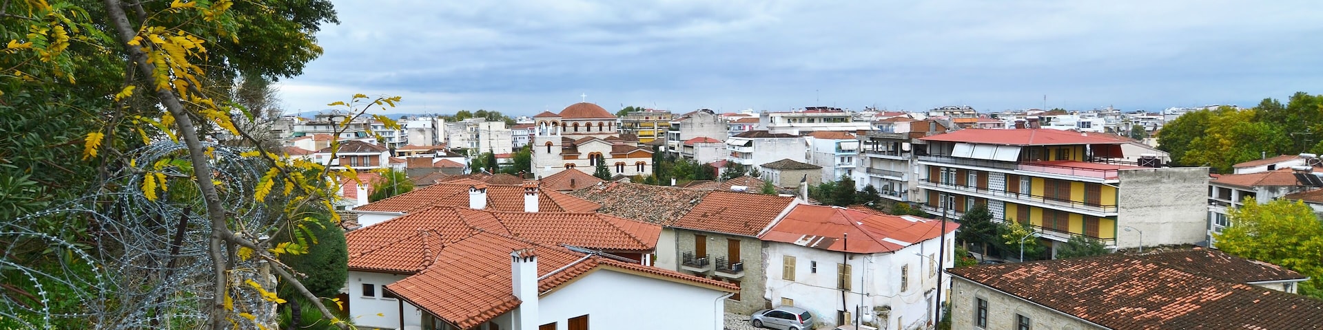 A town with red-tiled roofs, white buildings, and a mix of residential and commercial structures.