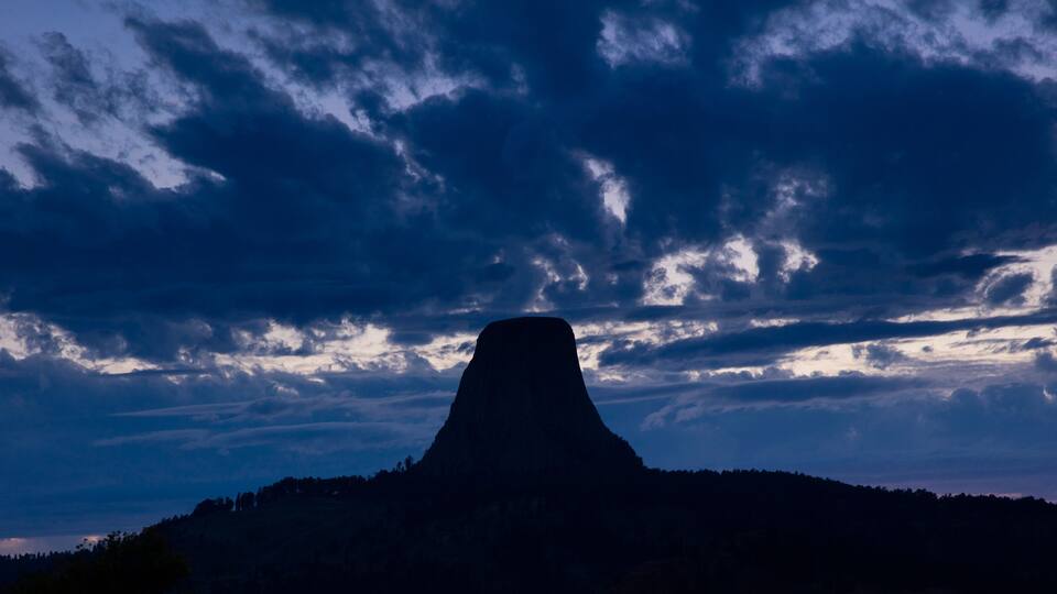 A mountain silhouette against a twilight sky.