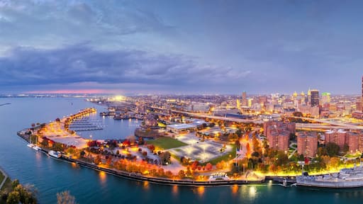 A cityscape with a prominent tower, waterfront promenade, and interconnected bridges.