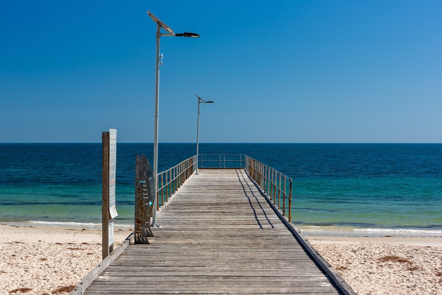 The iconic Normanville jetty with no people and blue skies on a bright sunny day on the Fleurieu Peninsula South Australia on 20th March 2019