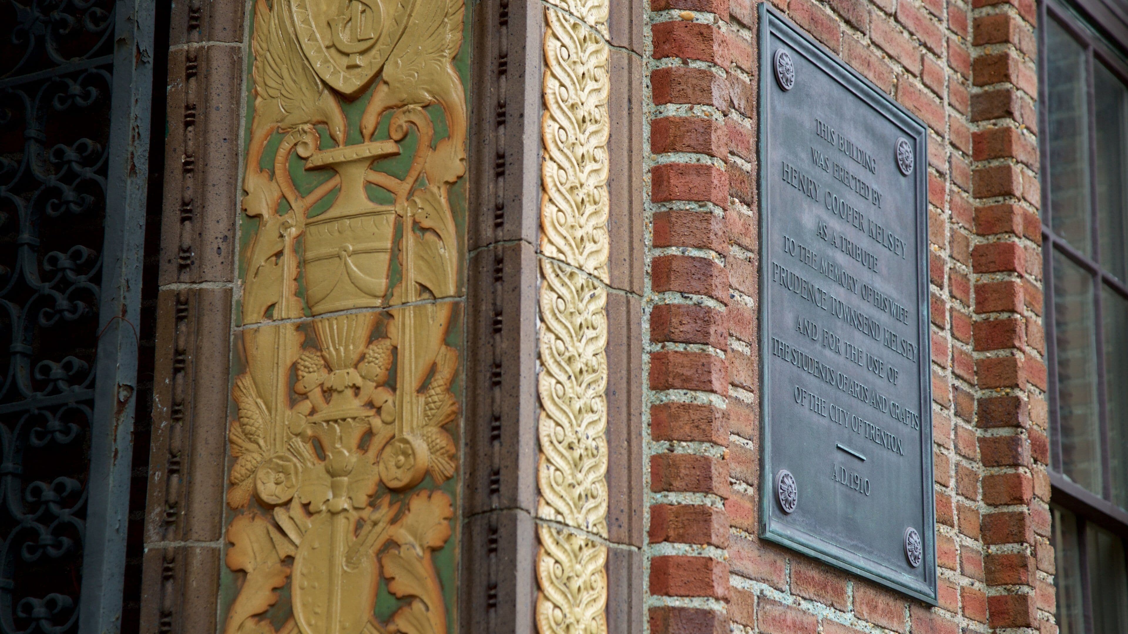A building facade with a plaque and ornate carvings.