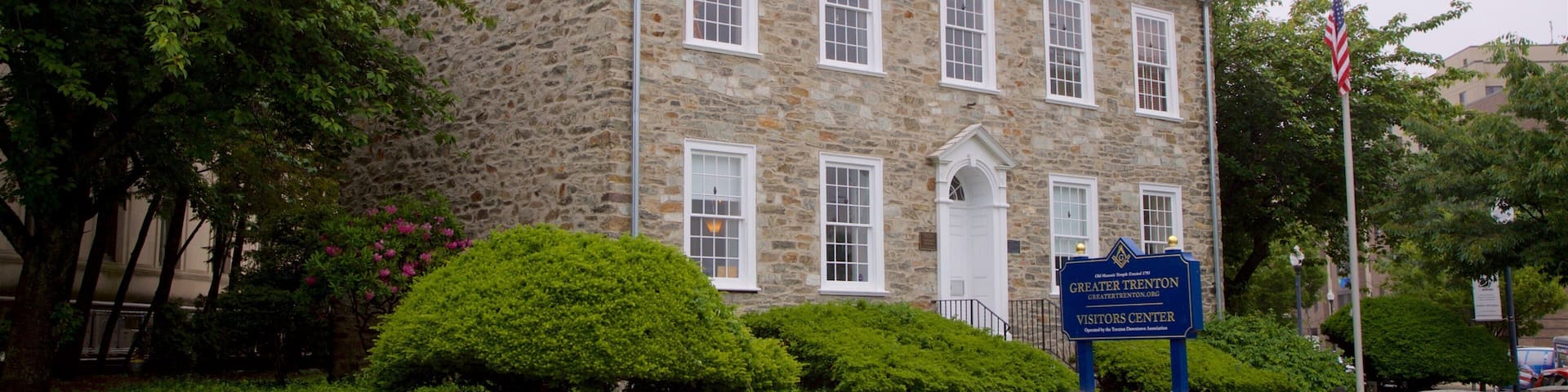 A stone building with a sign for the Greater Trenton Visitors Center.