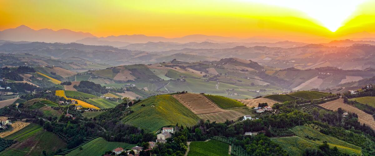 A valley with terraced fields and scattered houses.