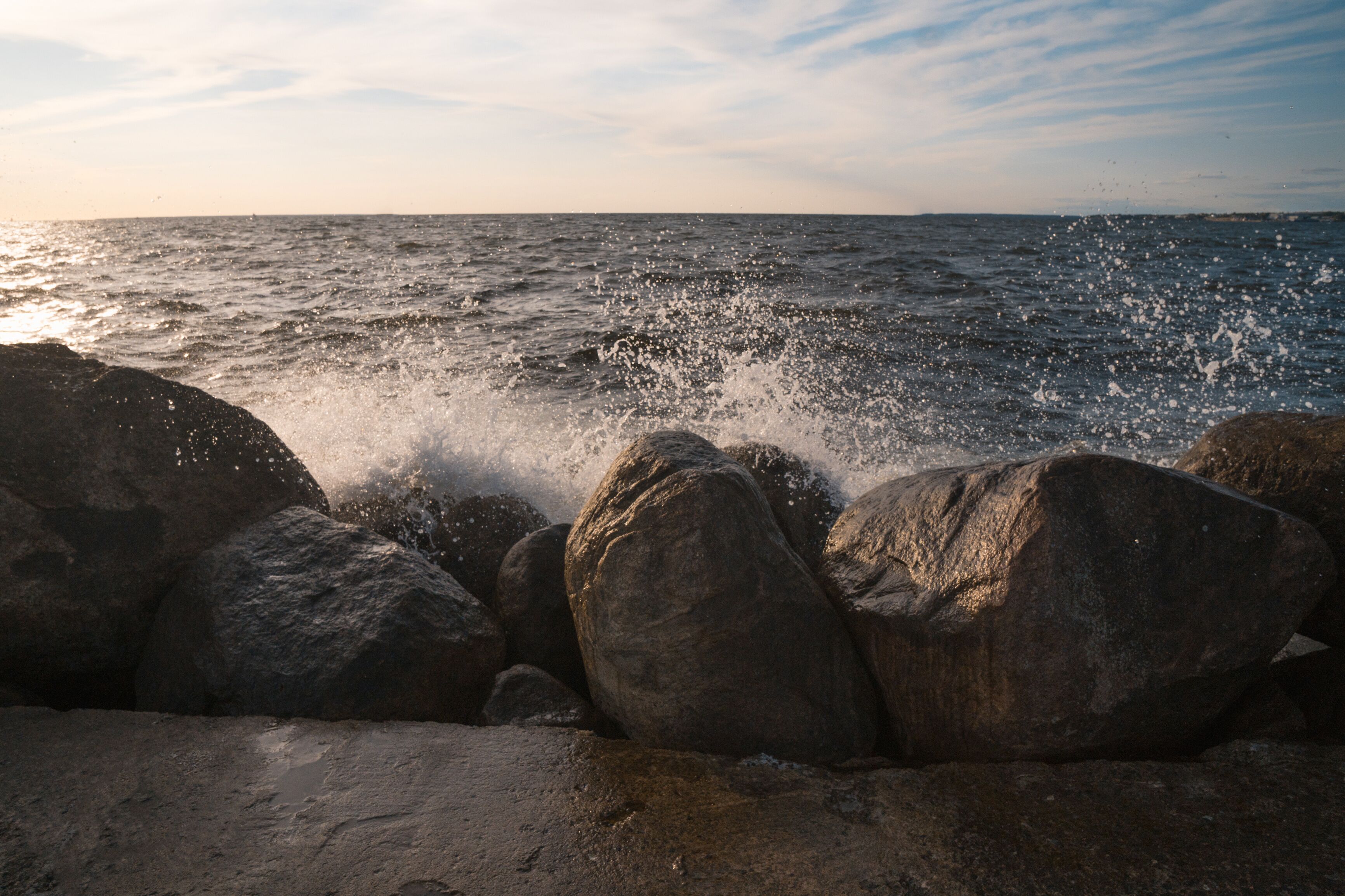 Powerful splashing waves by the rocks in Tallinn, Estonia, Europe. Beautiful sunny day.