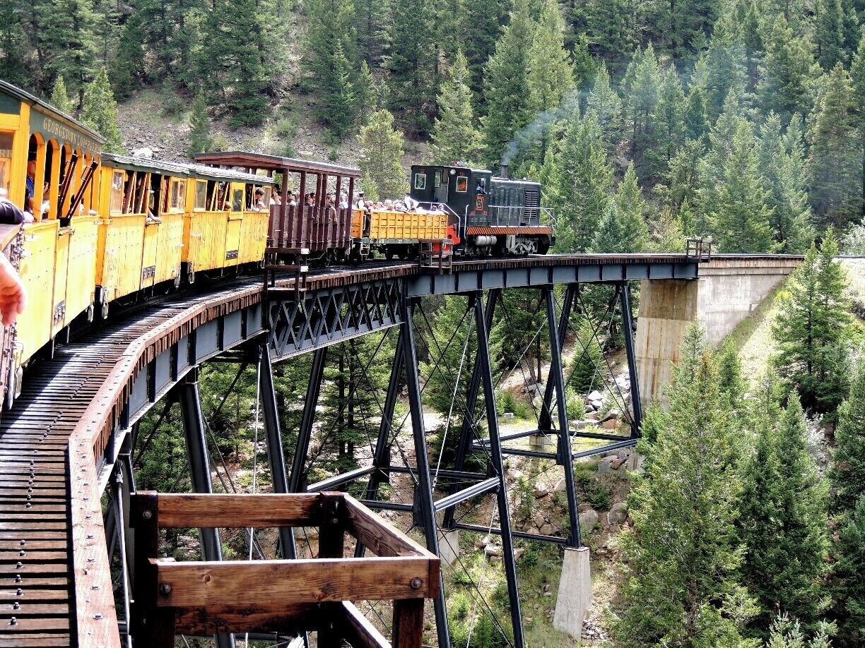 Georgetown's Historic Loop Railroad navigates the first of two hairpin curves designed to tackle the unprecedented 6% grade of Clear Creek Valley in the Front Range of Colorado's Rocky Mountains. Hauling silver down from the mines in Leadville 35 miles southwest of Georgetown was the driving force behind this stretch of track back in 1884.  Today, it's all a piece of the past, one that comes with considerable sentiment for train enthusiasts like my husband.  Read more about our ride via my blog at   http://www.aplacecalledroam.com/home/boom-is-back-on-georgetowns-historic-rail-line.  