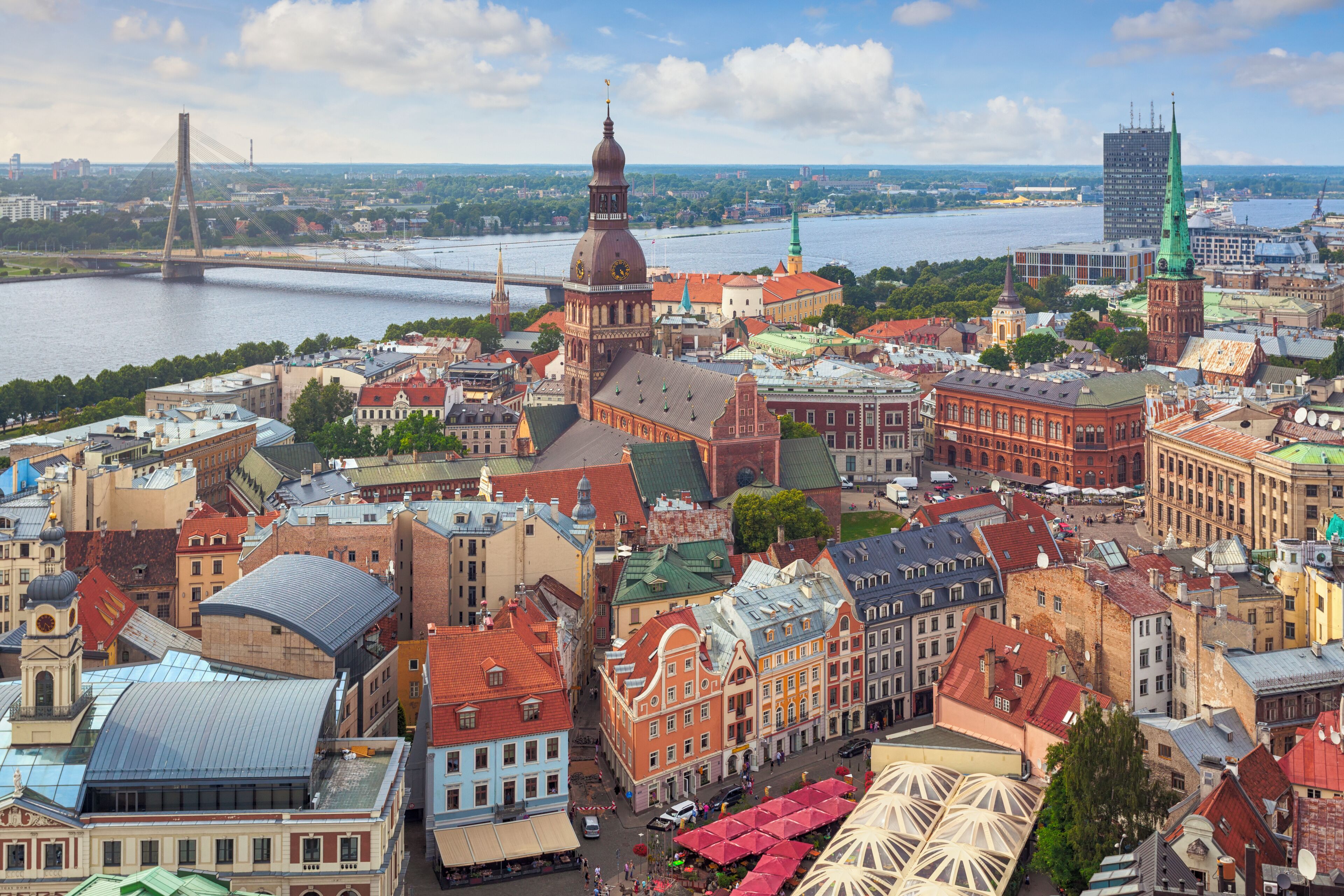 A cityscape with a prominent church, a river, and a bridge in the background.