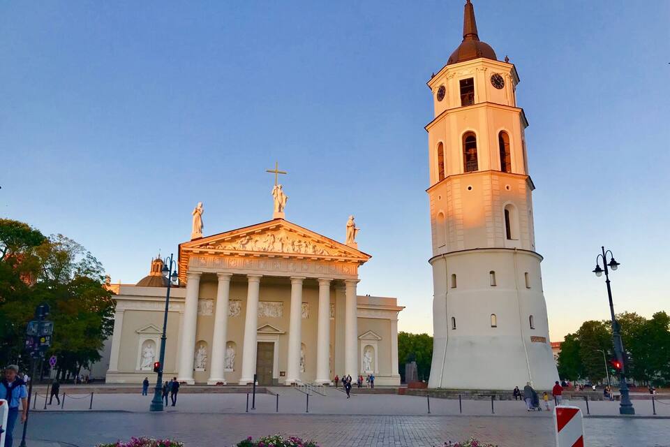 A classical building with columns and a bell tower.