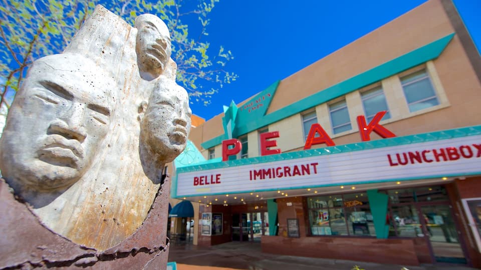 Downtown Colorado Springs featuring signage and a statue or sculpture