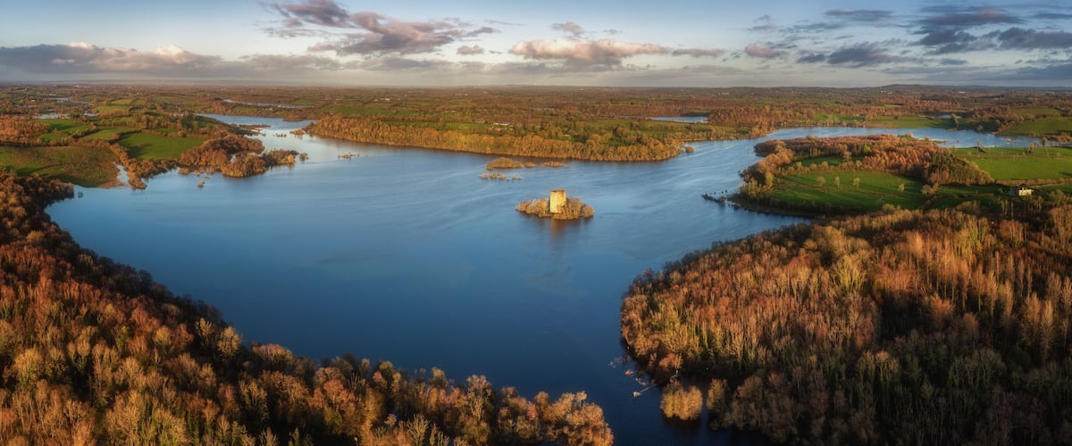 A river meandering through a forested landscape with a prominent island in the center.