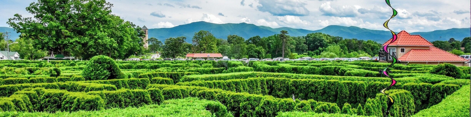 Eight foot tall hedges creating a pathway of puzzlement, misting fog, and endless confusion! Travel past fountains, through hidden tunnels, and over a lookout tower. 
Navigate your way through twists and turns while searching for hidden goals on a mission to discover the secret of the maze.
Unravel the mystery of the largest hedge maze in the Mid-Atlantic states - a one acre ornamental garden at Luray Caverns.
It is a fun filled activity for people of all age groups. The Garden of Maze is right next to the Luray Caverns. So if you plan a trip to see Luray Caverns, you can visit the maze too. Just let loose, get lost and be found at the maze ;)
Tip: The view from the lookout tower is beautiful like this one. Just sit back, take in the beauty and relax here. Also, its fun to see people getting lost in the maze ;P