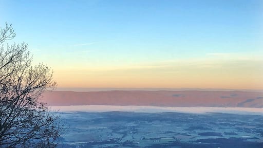 Just by the Skyland amphitheater is a building, on the top of an incline, facing west to Luray down below. There are four rooms here all with this breathtaking view made all the more gorgeous as the sun travels overhead and changes the color of the world below. At night, the stars are so vibrant that they can be seen while laying in bed. In the evening, the sunset is such an explosion of color it paints the walls. But in the early morning hours as the sun rises, it climbs on the other side of the mountain and slowly, gently, spreads over the valley floor. On this particular morning, it was below freezing and fog spread out through the valley, looking like a white ocean with waves that billowed and changed. The sun slowly burned away the fog, exposing a frost-covered land, and for a moment it felt like we were viewing the depths of a snowflake.
If you go to Skyland Resort in Shenandoah, spend the extra bucks for a good room with a view. Nearly all rooms overlook this valley in some way, but we splurged for a king bed and were so lucky to see this sight every morning with a warm cup of coffee in hand.
#findyourpark #mountains #nature #virginia #hiking #roadtrips