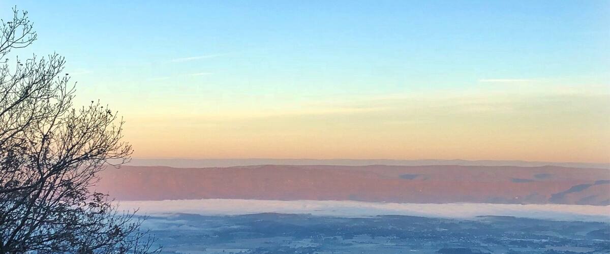 A panoramic view of a valley with a clear sky.
