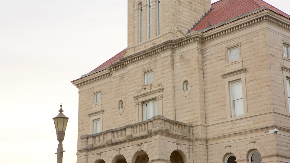 A historic building with a red-tiled roof and arched windows.