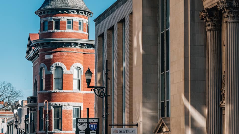 A historic building with a red brick tower and classical architecture.